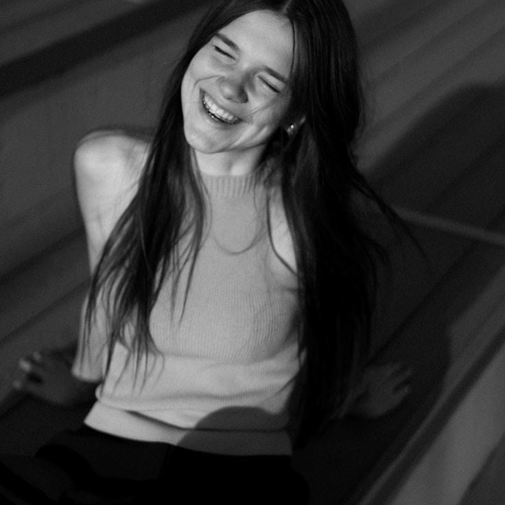 Anya Rao, Lead Design Curator at SteadySourceHaven, reviewing corporate floral arrangements